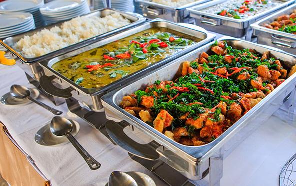 Bengali house warming and social event buffet — chafing dishes with rice, green curry, and stir-fried chicken — Parsha Caterer Kolkata