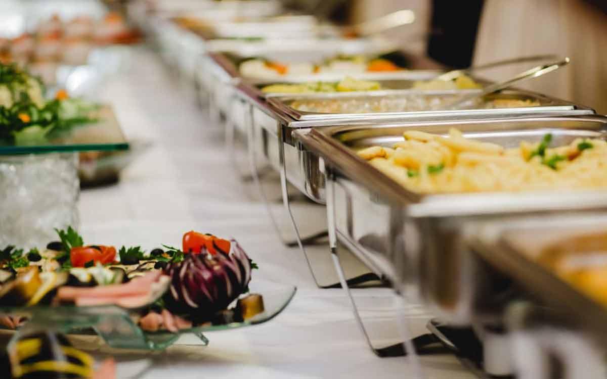 Elegant rice ceremony buffet line with appetizers and hot dishes for Mukhe Bhaat catering in Kolkata