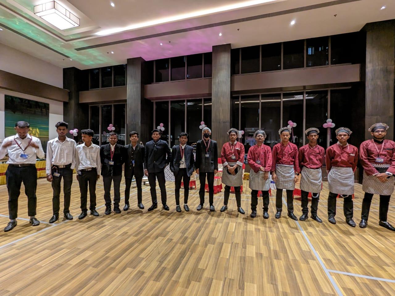 Catering team standing in formal uniforms
